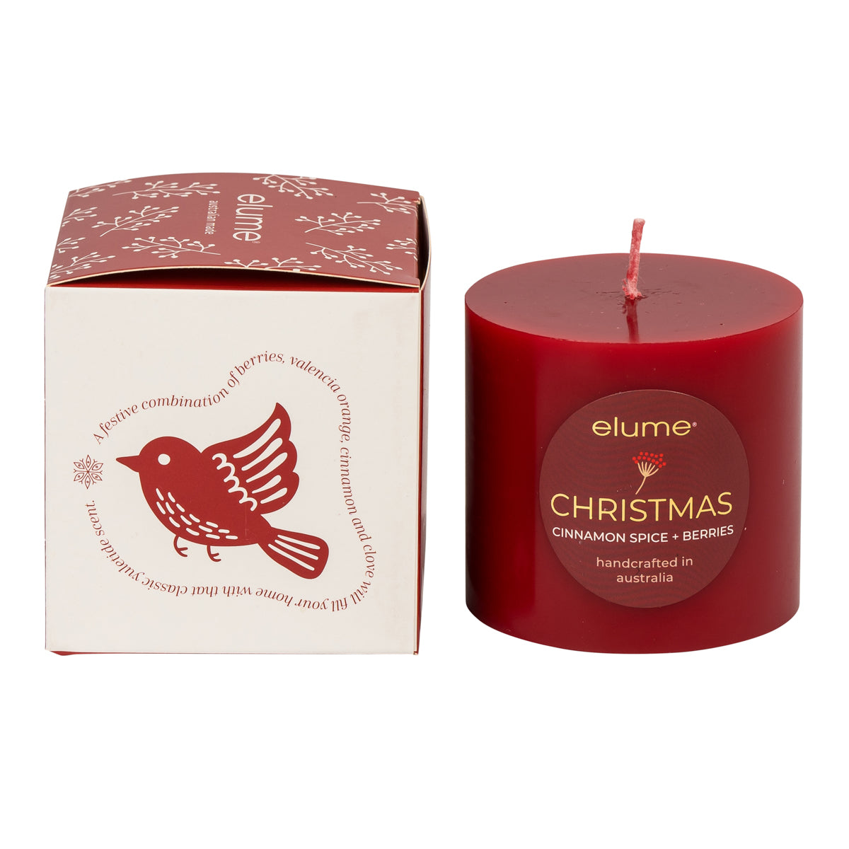 Red candle with 'elume' branding next to its packaging on a white background