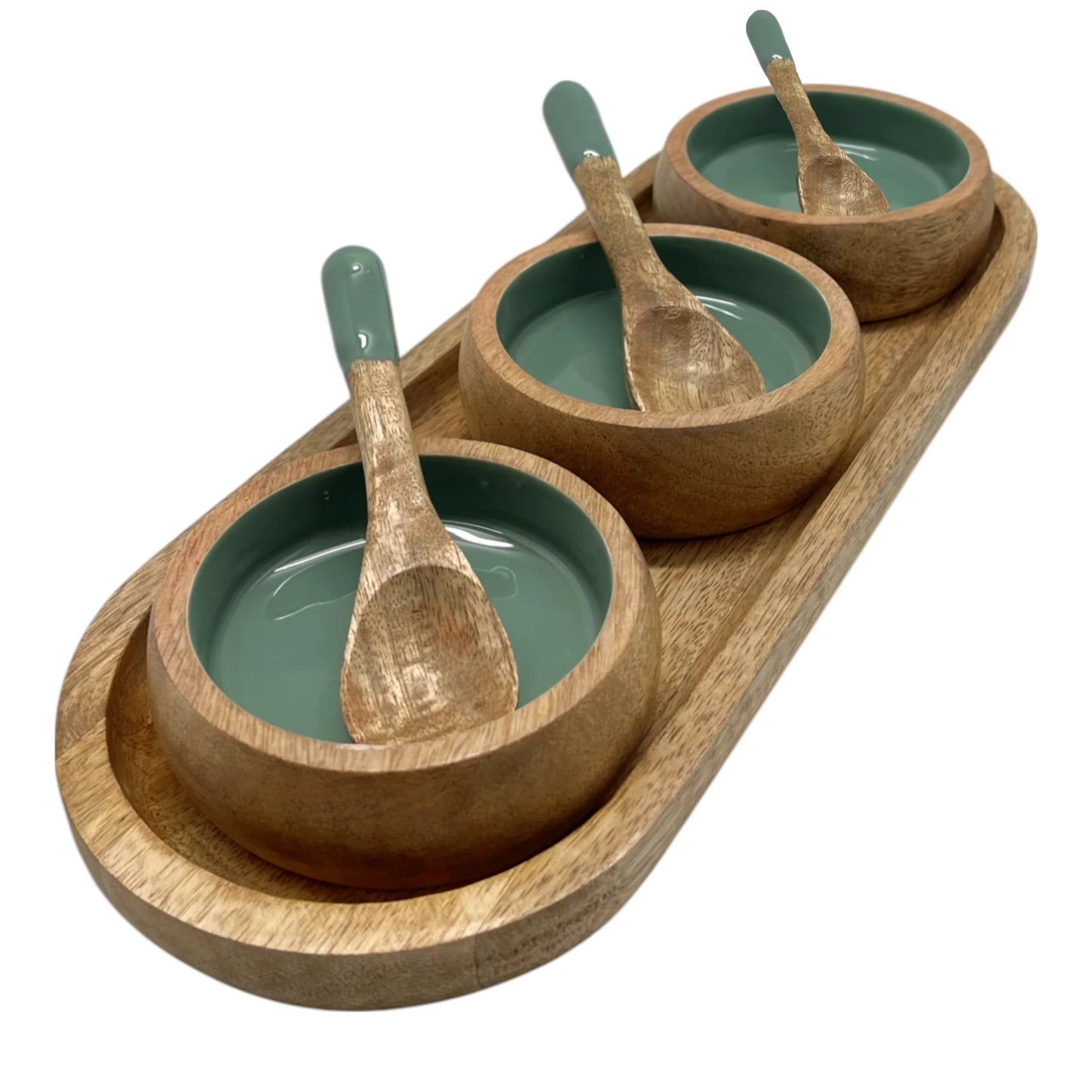 Set of wooden bowls with green interior and wooden spoons on a white background