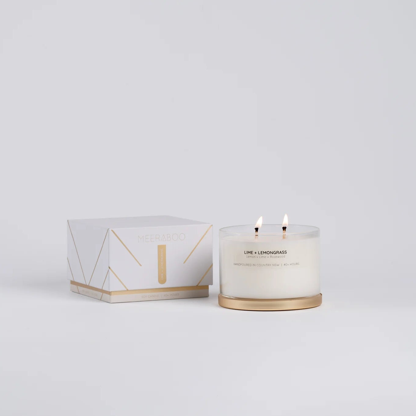 Candle with packaging on a light gray background