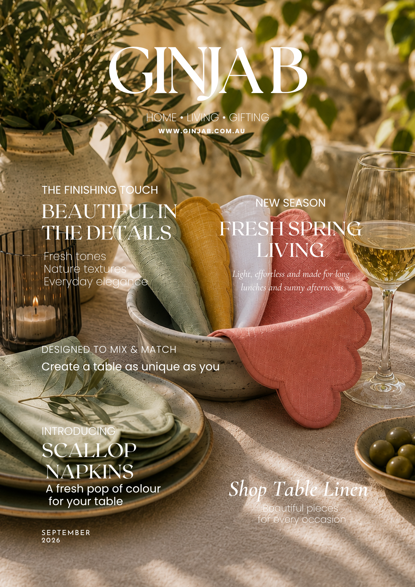Ginab home decor magazine cover featuring a styled table setting with green and pink table linens, folded napkins in a ceramic basket, a glass of white wine, and olive branches in the background.