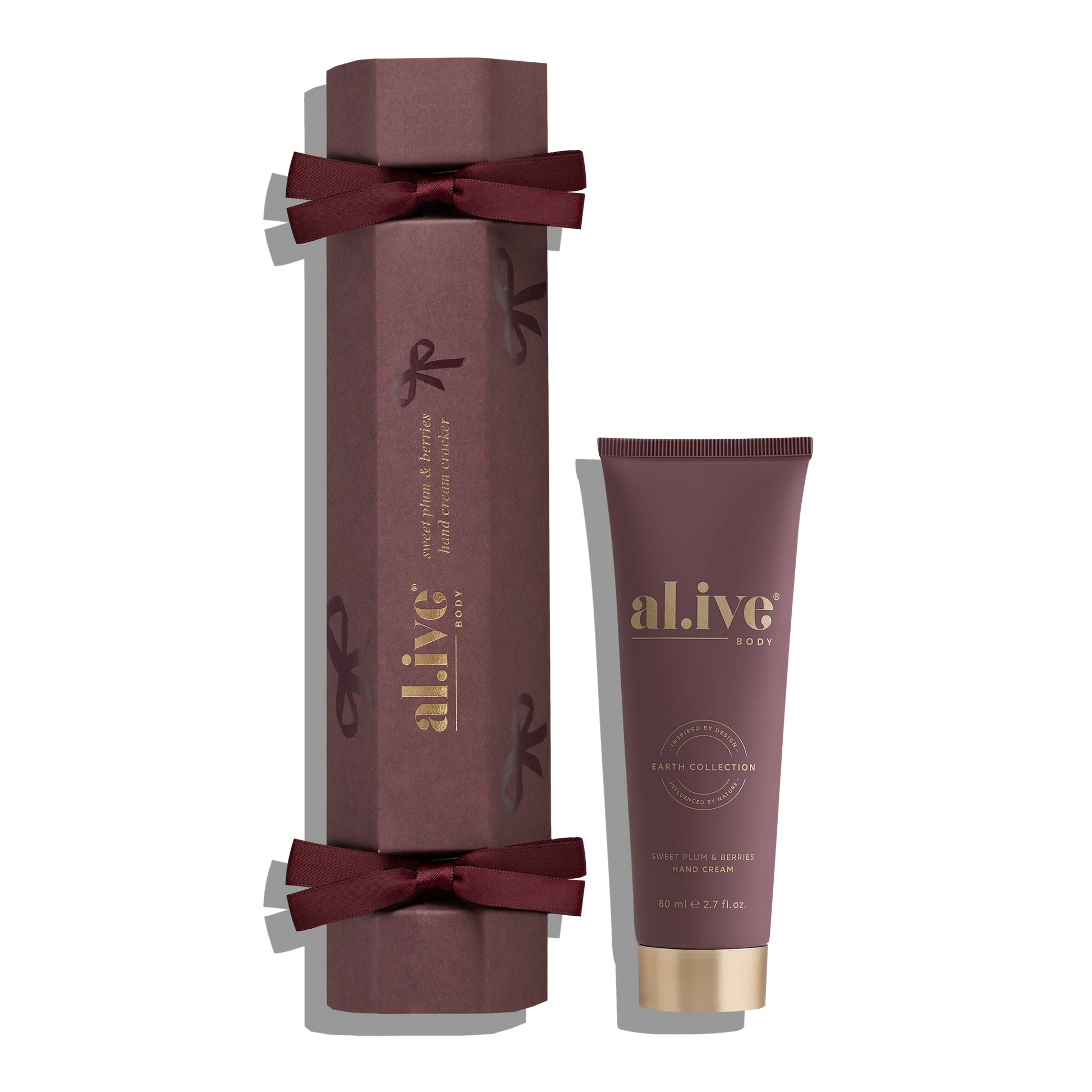 Maroon gift box with a tube of 'al.ive' body product on a white background
